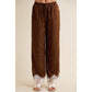 Brown satin wide leg pants with white polka dots and lace trim at the hem.